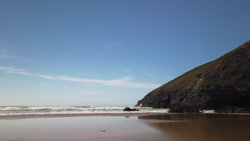 Waves and cliff edge at Mawgan Porth Beach, Cornwall.  Real time. Royalty-Free Stock Footage #1101597367