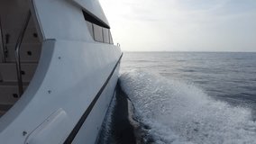 Yacht cruising on the sea, motor yacht in motion on the sea, yacht cruise, side view of the yacht in motion on the sea