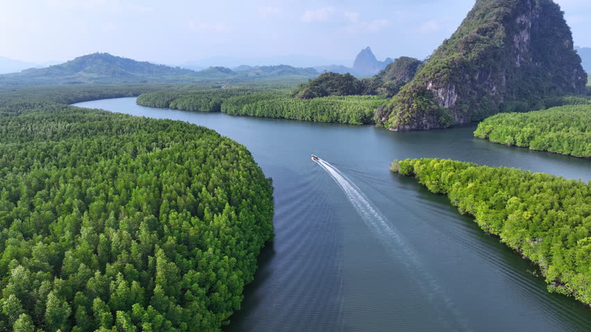 Aerial view of Longtail boat sailing at Phang Nga bay in Thailand.