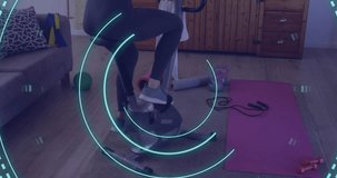 Animation of data processing over caucasian woman exercising, using stationary bike. Global fitness, digital interface and connections concept digitally generated video.
