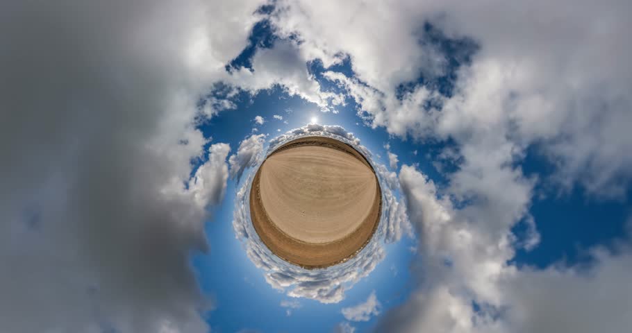 Tiny planet transformation with curvature of space among fields on gravel road in sunny day with sky and fluffy clouds | Shutterstock HD Video #1101606459
