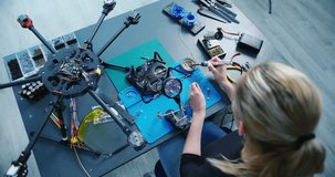 Engineer working on racing fpv drone combat kamikaze bomber in workshop. - Powered by Shutterstock - Get 15% off with code: PIKWIZARD15