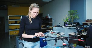 Engineer working on racing fpv drone combat kamikaze bomber in workshop.