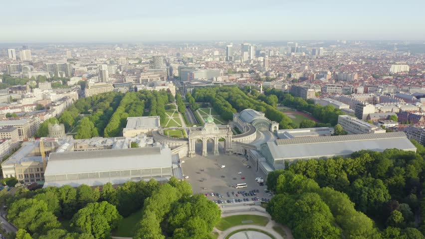 Inscription on video. Brussels, Belgium. Park of the Fiftieth Anniversary. Park Senkantoner. The Arc de Triomphe of Brussels (Brussels Gate). Appears from the sand, Aerial View