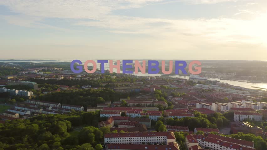 Inscription on video. Gothenburg, Sweden. Panorama of the city and the river Goeta Elv with ships. Sunset. Multicolored text appears and disappears, Aerial View | Shutterstock HD Video #1101609813
