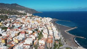 Aerial drone footage of the beautiful town of Santa Cruz de La Palma Santa Cruz de Tenerife in Spain showing hotels and residential houses by the Playa de Santa Cruz de La Palma beach. - Powered by Shutterstock - Get 15% off with code: PIKWIZARD15