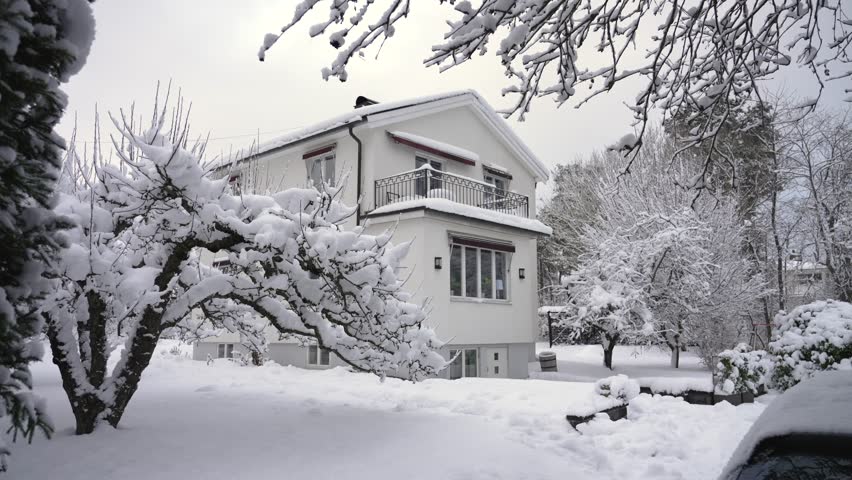Dream house in winter. heavy snow on apple tree and ground. Snowy white garden. Expensive and exclusive real estate villa in Stockholm Sweden suburb. family home in nature | Shutterstock HD Video #1101612231
