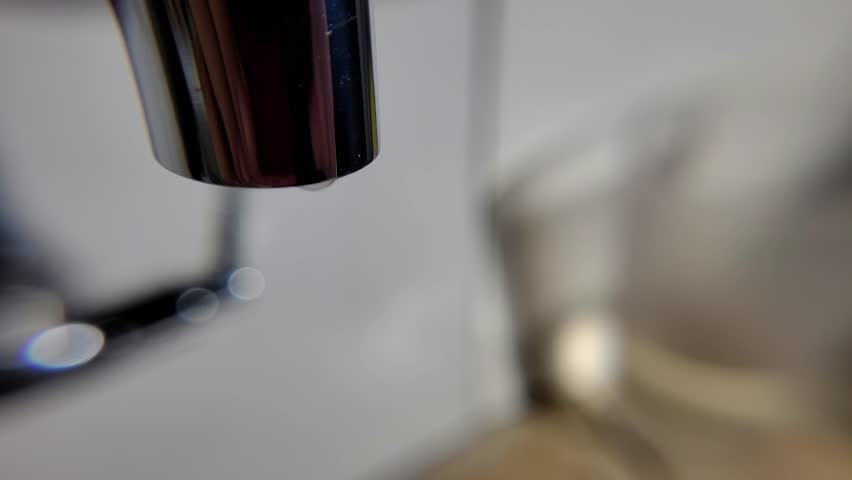 Drops of water, water drops falling from a faucet in slow motion, 4k, natural light, selective focus. | Shutterstock HD Video #1101612973