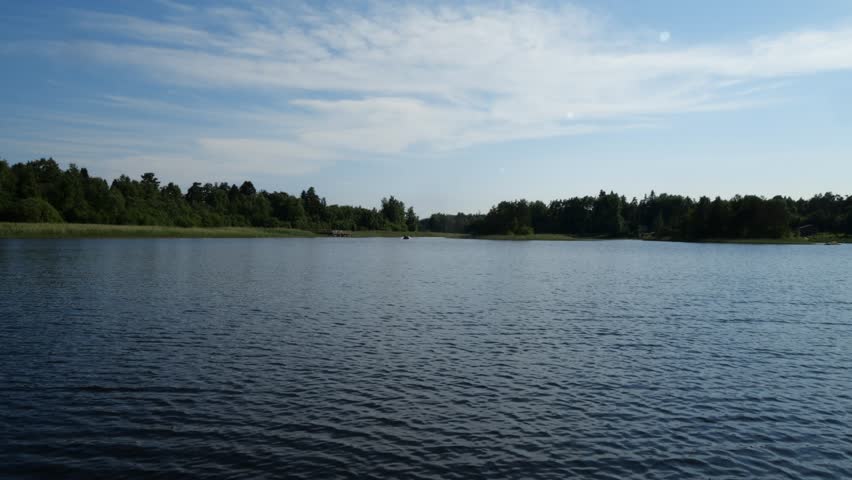 A motorboat rushes through the waves on the lake | Shutterstock HD Video #1101613095