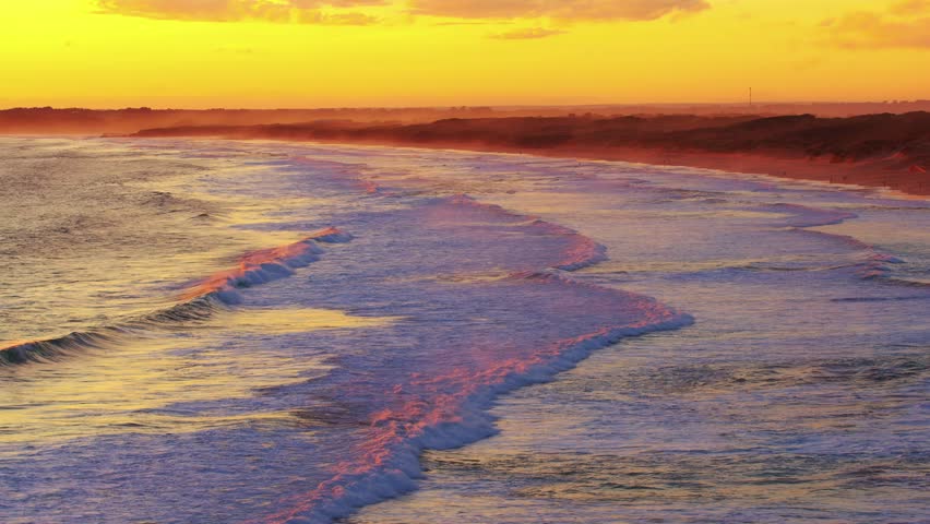 Ocean waves in contrasting orange sunlight on an ocean shore in a calm windless weather, Lagoon on Phillip Island, Victoria, Australia | Shutterstock HD Video #1101614325