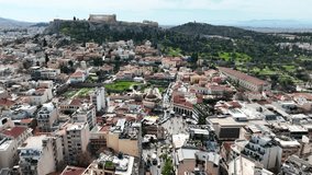 Aerial drone cinematic video of iconic Acropolis hill and the Parthenon as seen from picturesque Plaka and Monastiraki districts - Roman forum, Athens historic centre, Attica, Greece