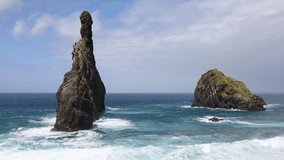 4K video of a sunny day on a rocky beach in Madeira at the Ribeira da Janela rock.