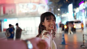Point of view young Asian woman holding hands with boyfriends walking down city street at night. Happy couple enjoy and fun outdoor lifestyle shopping and travel in the city on summer holiday vacation - Powered by Shutterstock - Get 15% off with code: PIKWIZARD15