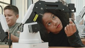 Group Kid teen child enjoy Machine Learning Robot arm is Moving Under coding Control robot at stem technology class, stem education for digital automation learn for use artificial intelligence ai - Powered by Shutterstock - Get 15% off with code: PIKWIZARD15