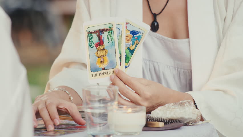 Fortune teller reading tarot cards, doing a reading for a client. | Shutterstock HD Video #1101618309