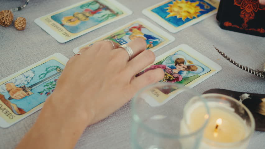 Fortune teller reading tarot cards, doing a reading for a client. | Shutterstock HD Video #1101618313