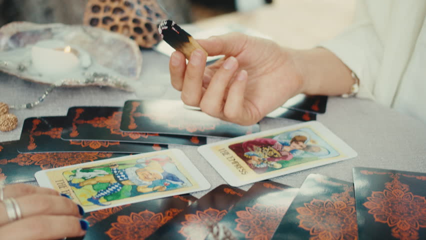 Fortune teller reading tarot cards, doing a reading for a client. | Shutterstock HD Video #1101618331