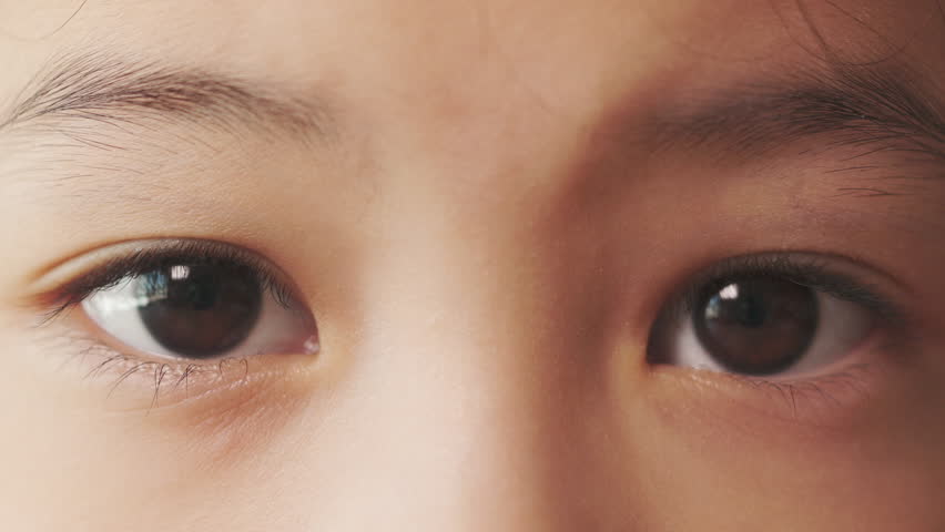 Close up 4K with slow motion of 6 years old Asian girl who is looking forward shows beautiful black eyes with iris pupil. It shows concept of visionary of child and young people with serious thinking. Royalty-Free Stock Footage #1101623117
