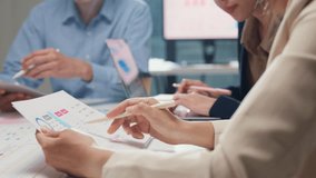 Closeup happy young Asia businesspeople meeting brainstorming some new ideas about project to his partner working together planning success strategy enjoy teamwork in small modern home office. - Powered by Shutterstock - Get 15% off with code: PIKWIZARD15