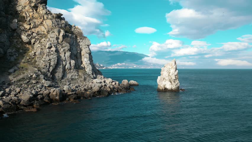 beautiful seashore of the Crimean peninsula in spring , rocks and sea against the sky and clouds