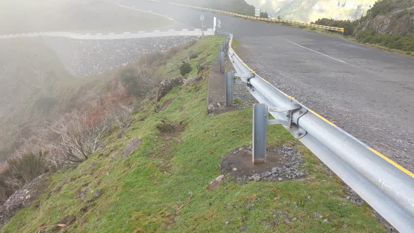 View of a high mountain road with fog.