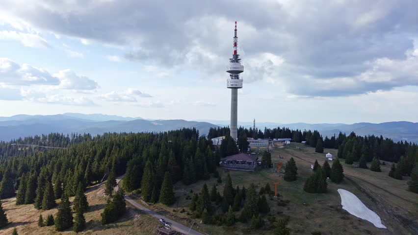 Tower Snezhana on peak of Snezhana covered with spruce forests in Rhodope mountains