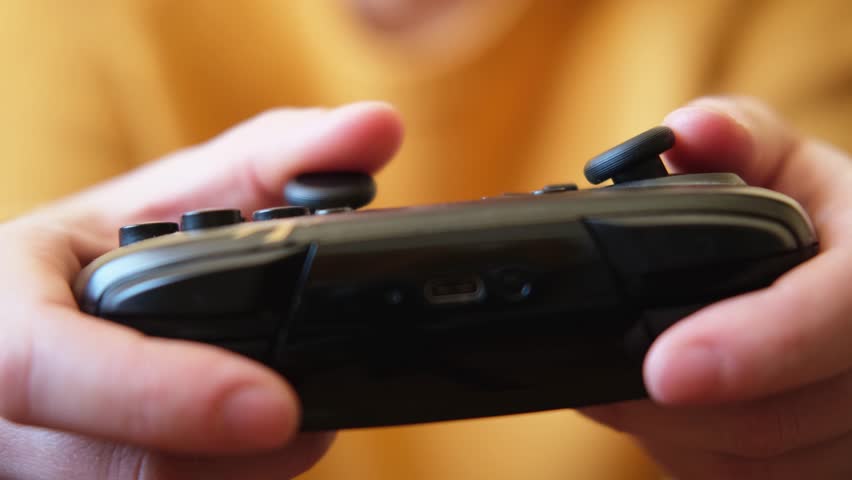 Woman hands holding black joystick gamepad playing game console. Computer gaming competition videogame control concept. Using controller playing video games. Cyberspace symbol. Hands joypad close up