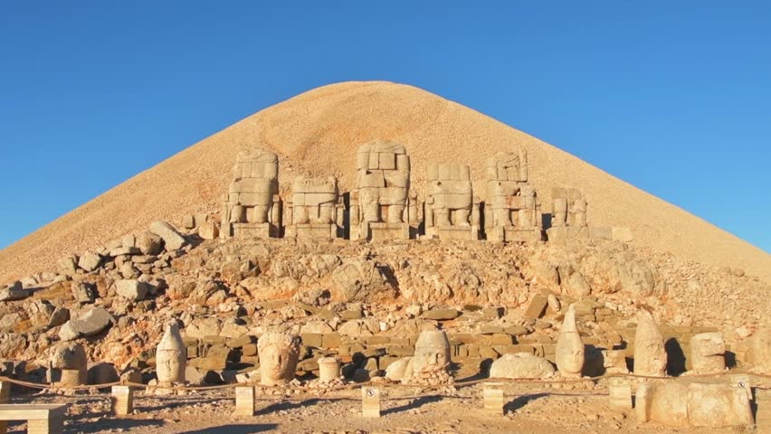 Zoom in front view Statues wit heads on top of the Nemrut Mountain in Adiyaman, Turkey. Morning sunrise east side Nemrut Dagi Royalty-Free Stock Footage #1101637311