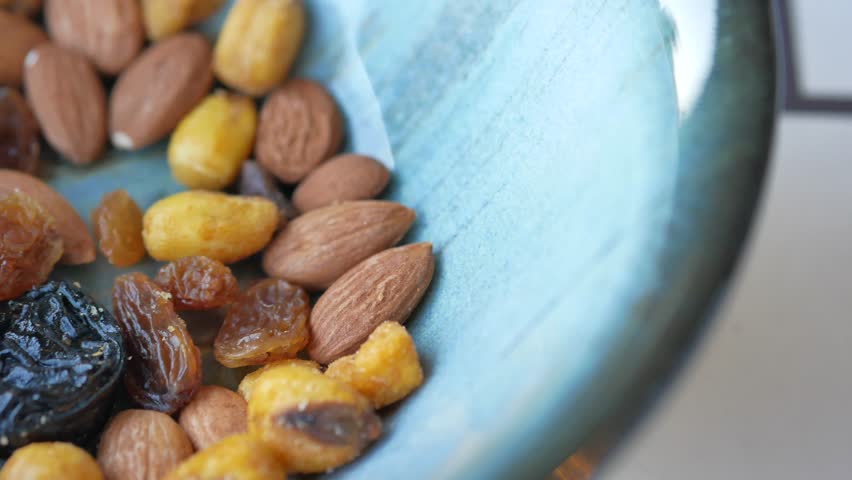 close up of many mixed nuts in a bowl 