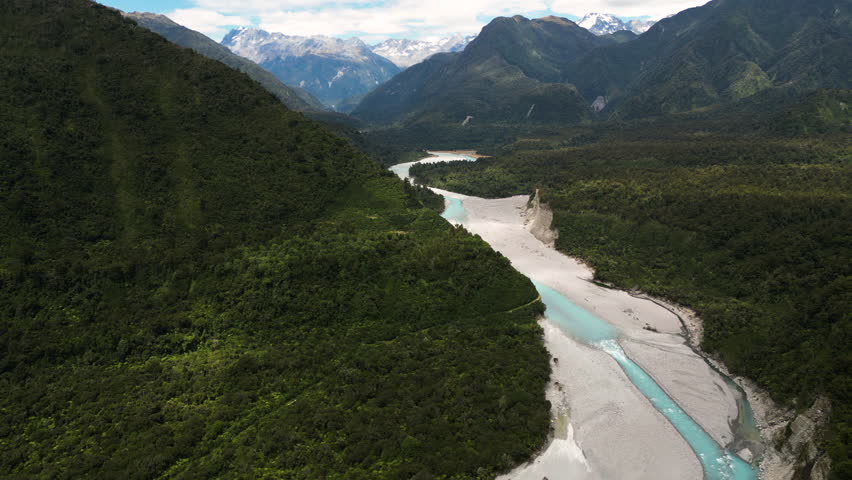 aerial stunning landscape from NZ new Zealand with stream river in mountains valley from Fox Glacier
