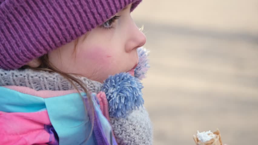 Cute Caucasian Girl Kid Eating Tasty Wafer Tube Filled with Sweet Whipped Cream