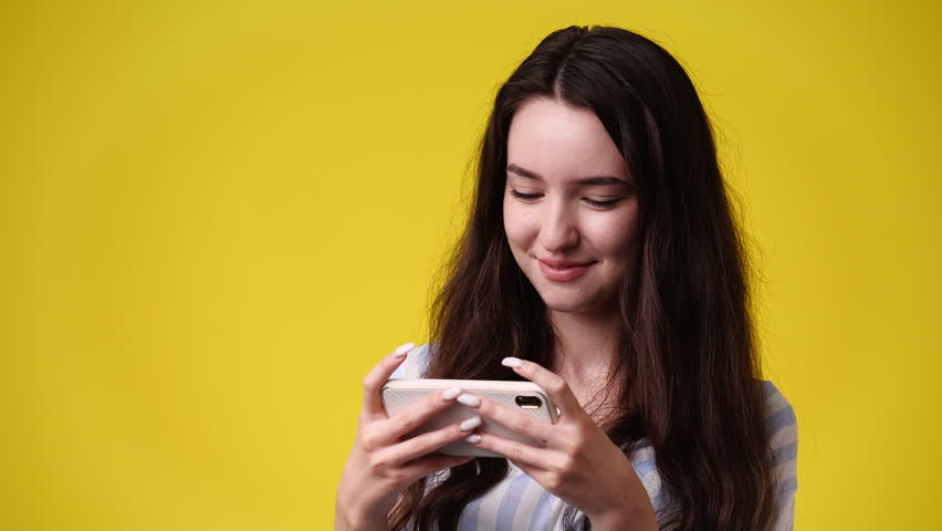 4k video of one girl sending messages on yellow background. | Shutterstock HD Video #1101641389