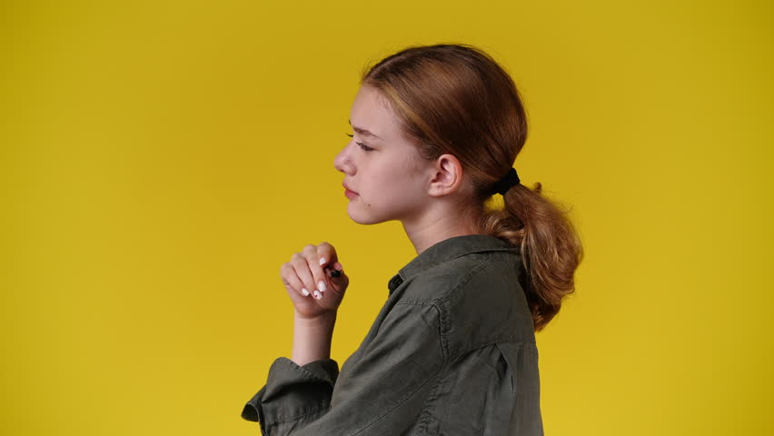 4k video of one girl posing for a video over yellow background. | Shutterstock HD Video #1101641411