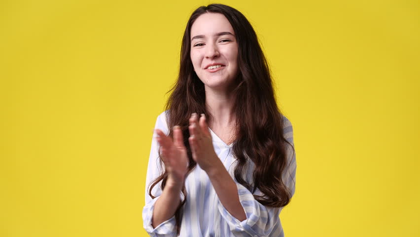 4k video of girl with cunning facial expression on yellow background. | Shutterstock HD Video #1101641415