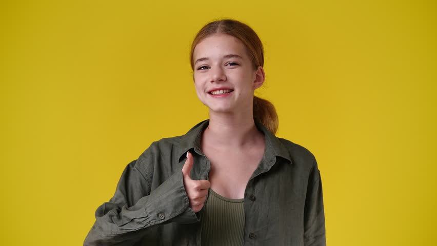 4k video of one girl showing thumbs up over yellow background. | Shutterstock HD Video #1101641417
