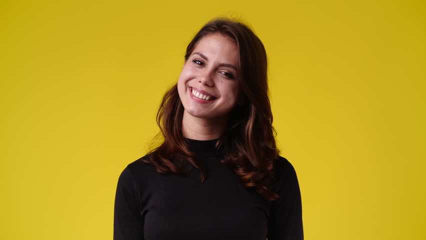 4k video of one girl posing for a video over yellow background. | Shutterstock HD Video #1101641421