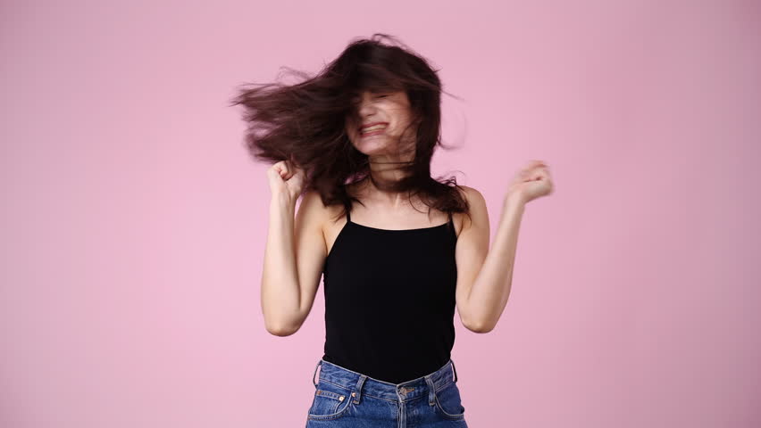 4k video of one girl is so excited about something over pink background. | Shutterstock HD Video #1101641425