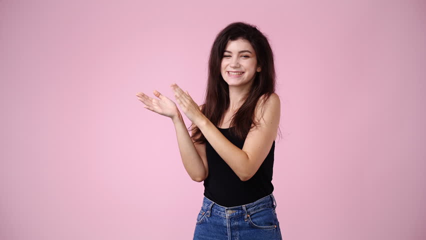 4k video of excited girl clapping in hands on pink background. | Shutterstock HD Video #1101641435