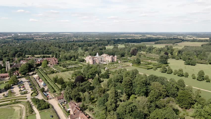 Aerial view rising over majestic Hatfield house Tudor mansion glorious landscaped gardens and parkland
