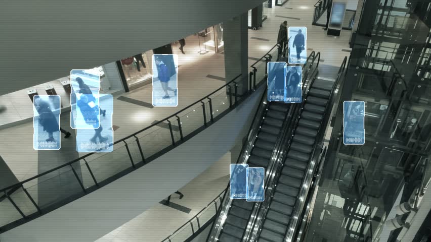 CCTV with facial recognition identifies people in a crowd. Scanning persons on an escalator in a shopping mall with a security video camera. Interface of software that uses big data analysis. 4k | Shutterstock HD Video #1101642615