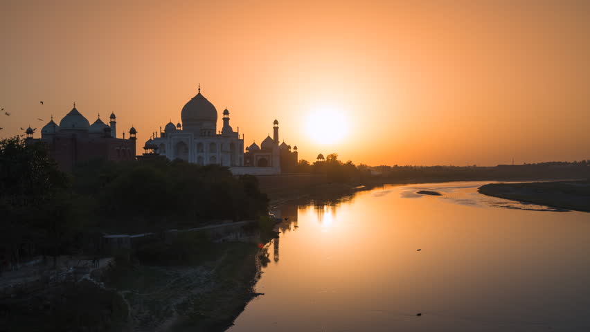 Timelapse view of sunset over the Taj Mahal and Yamuna River in Agra, India.  Royalty-Free Stock Footage #1101644653