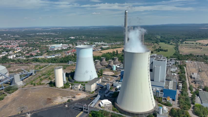 Aerial view of chimneys of power plant, an industrial district. Modern large thermal power plant in Germany, Europa. Generation through coal switched over to natural gas