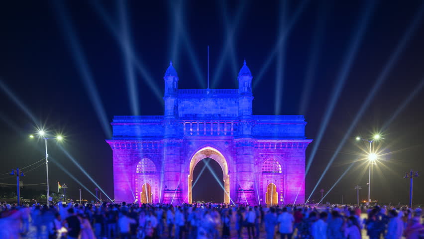 Timelapse view of historic landmark Gateway of India monument illuminated at night in Mumbai, Maharashtra, India. 