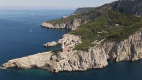 Aerial footage of the lighthouse Faro di punta Carena recorded with drone flying over the island of Capri