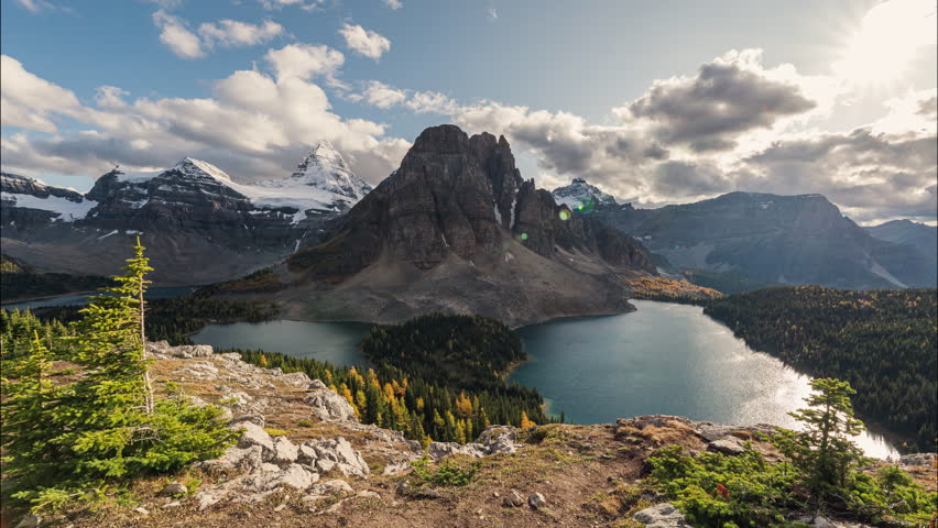 Time lapse scenery of Mount Assiniboine with Sunburst Lake and Cerulean Lake in autumn forest on Niblet viewpoint in Assiniboine provincial park at BC, Canada