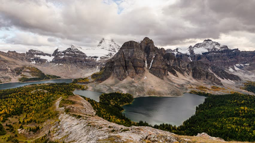 Time lapse scenery of Mount Assiniboine with Sunburst Lake and Cerulean Lake in autumn forest on Nublet viewpoint in Assiniboine provincial park at BC, Canada