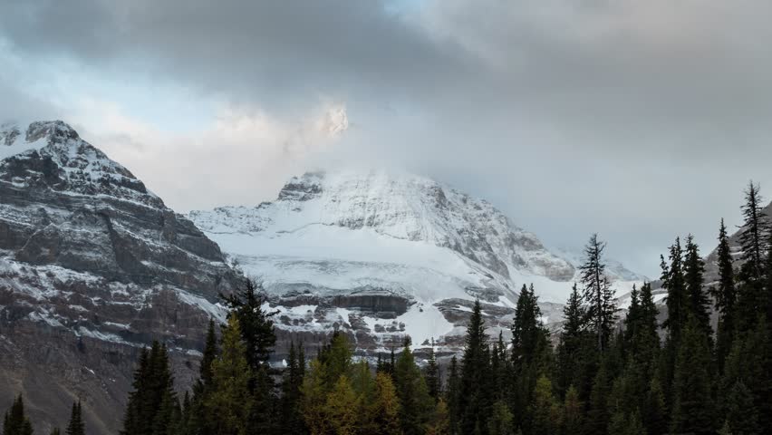 Time lapse scenery of Mount Assiniboine with cloudy blowing in autumn forest at Assiniboine provincial park, BC, Canada