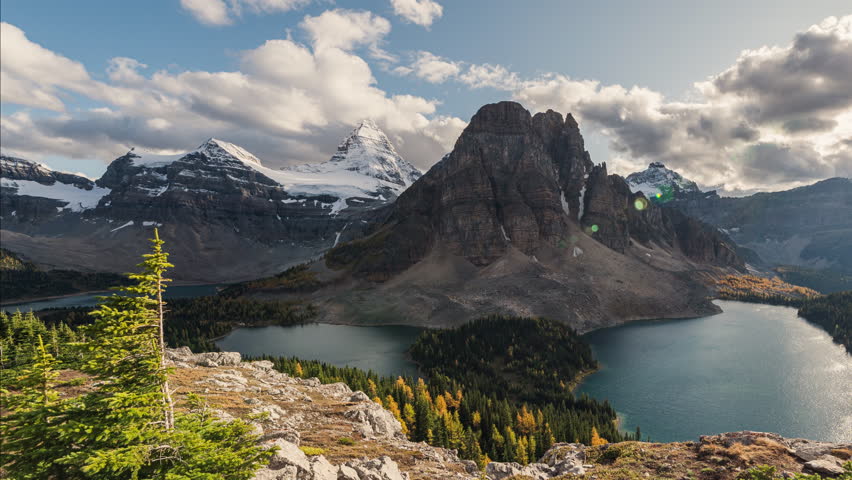 Time lapse scenery of Mount Assiniboine with Sunburst Lake and Cerulean Lake in autumn forest on Niblet viewpoint in Assiniboine provincial park at BC, Canada
