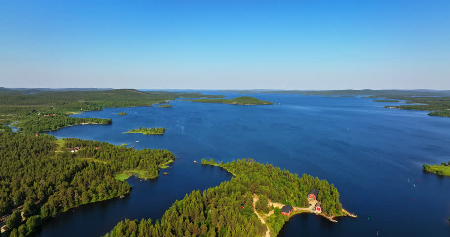 Aerial view overlooking islands on lake Inari, summer in north Finland - tracking, drone shot