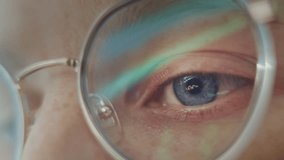 Close up of a female bright blue eye with glasses, looking at tablet screen and browsing the cryptocurrency price chart. Screen reflection in the computer glasses. Working late at night. - Powered by Shutterstock - Get 15% off with code: PIKWIZARD15